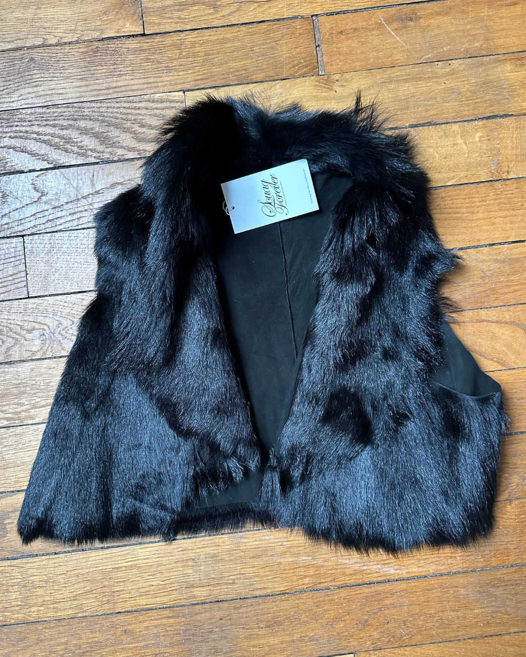 Short black fur vest