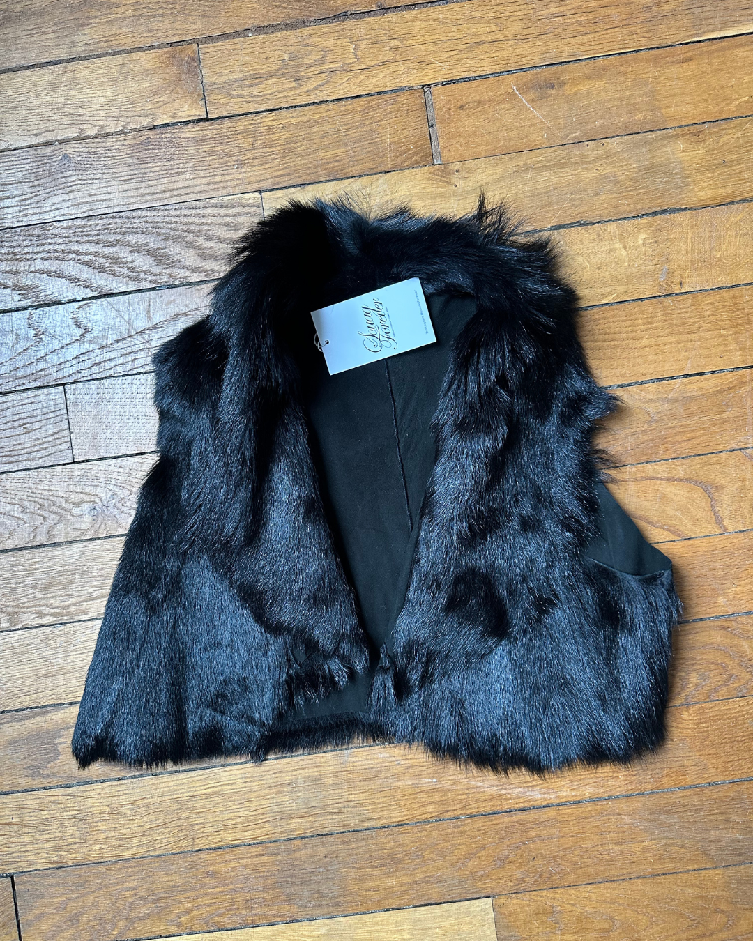 Short black fur vest