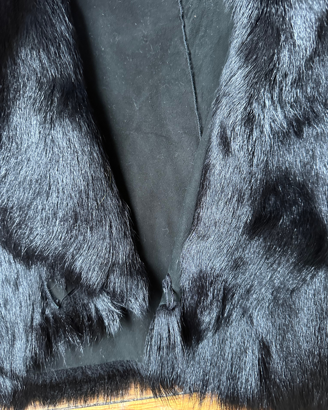 Short black fur vest