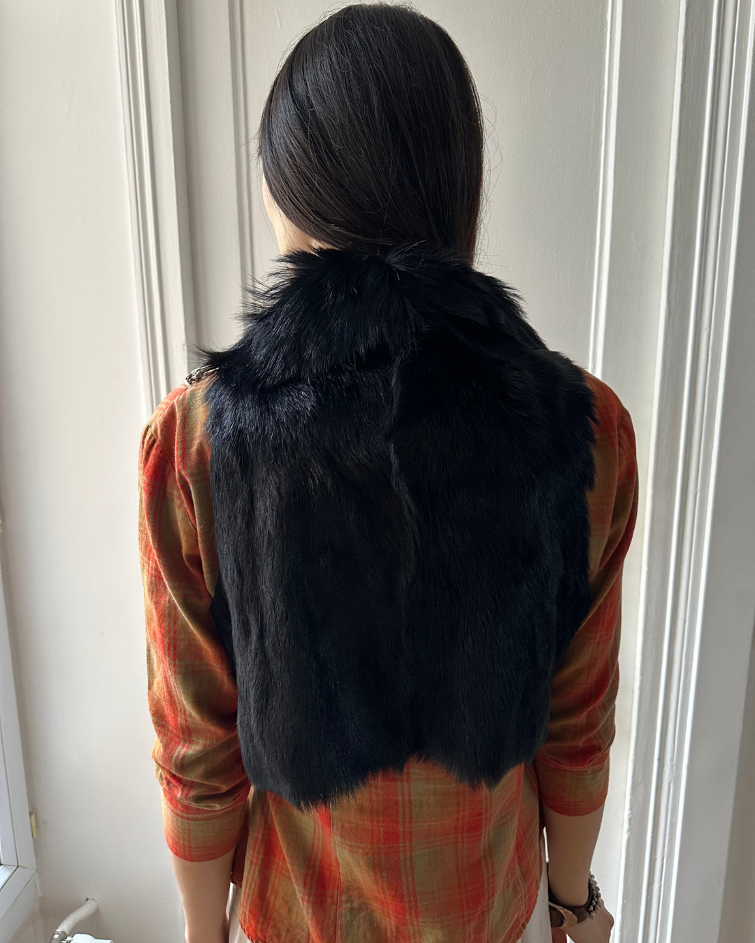Short black fur vest