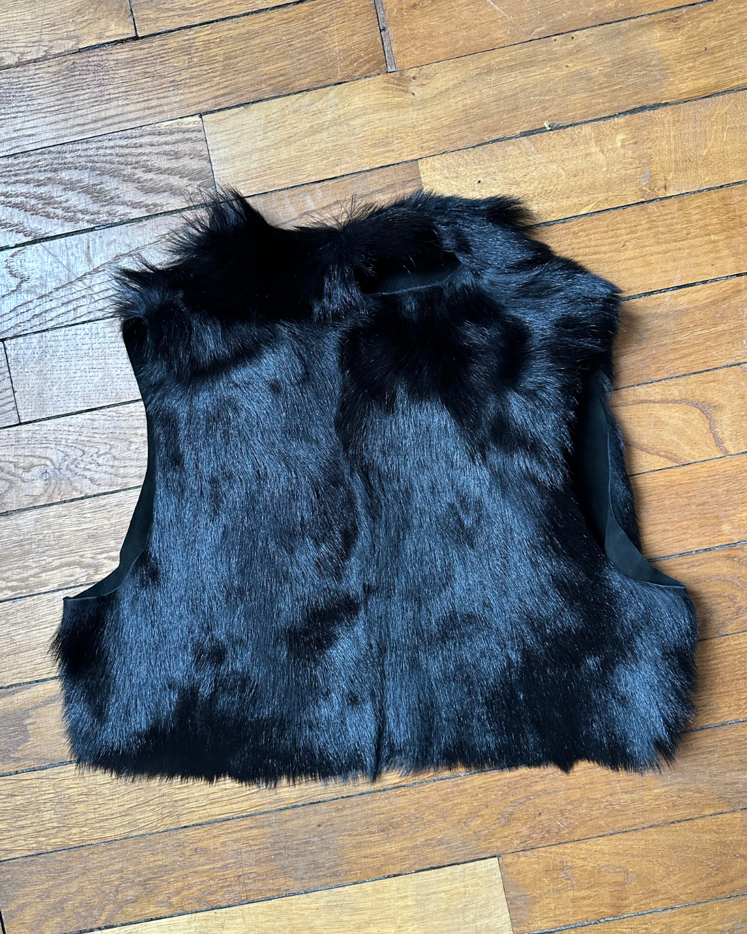 Short black fur vest