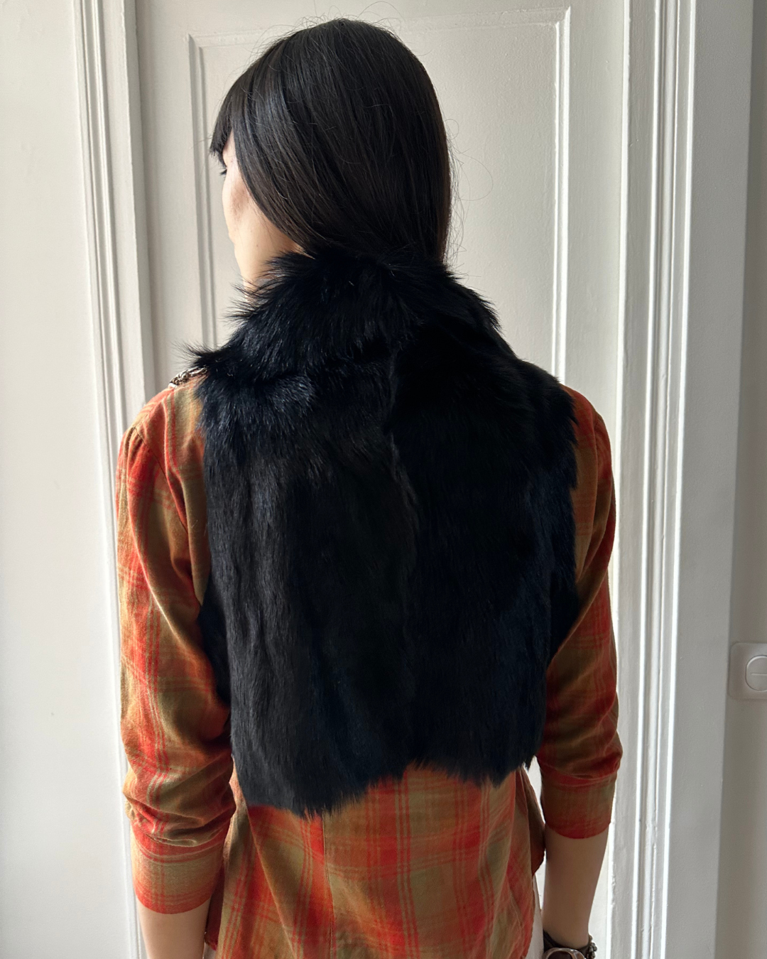 Short black fur vest