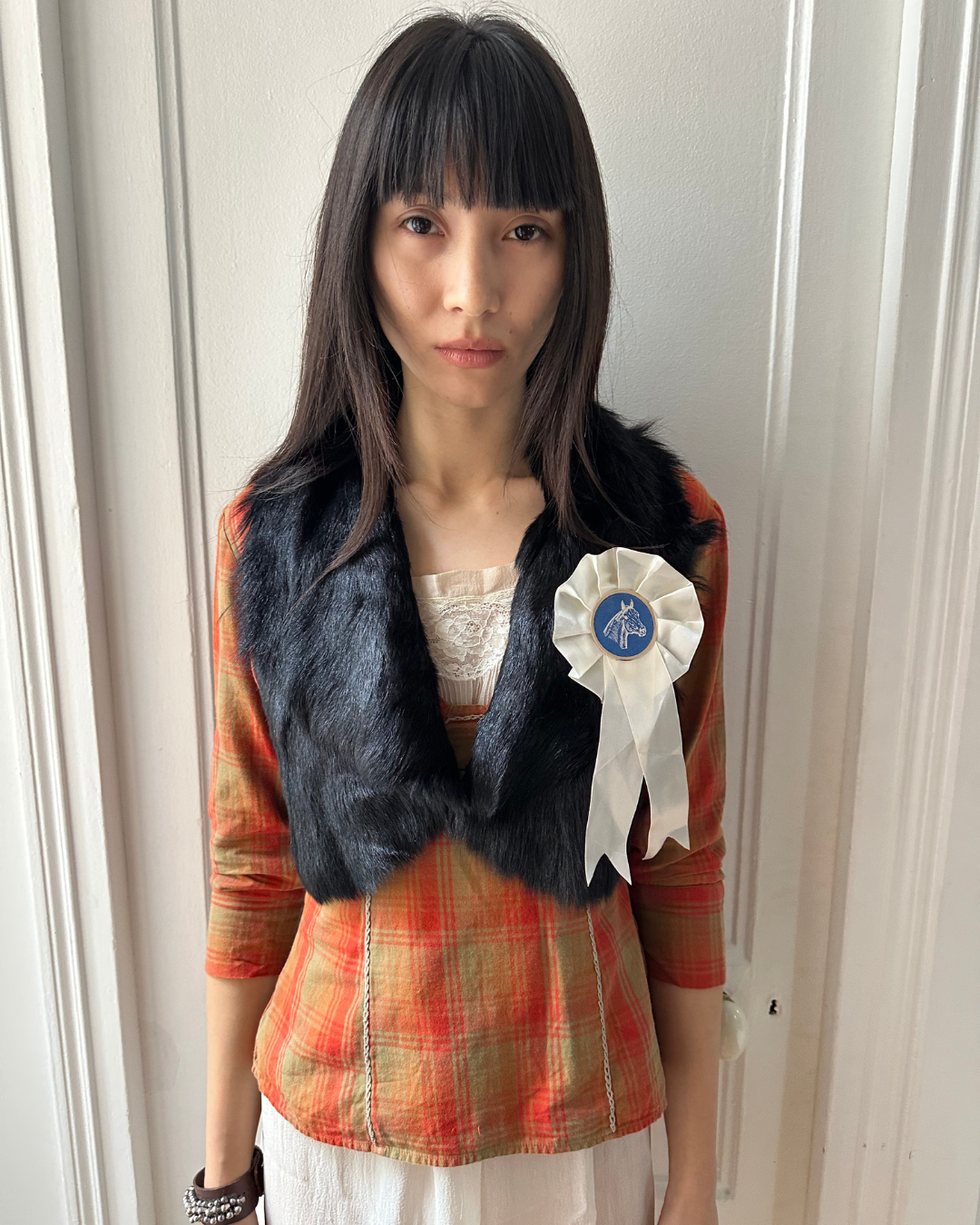 Short black fur vest